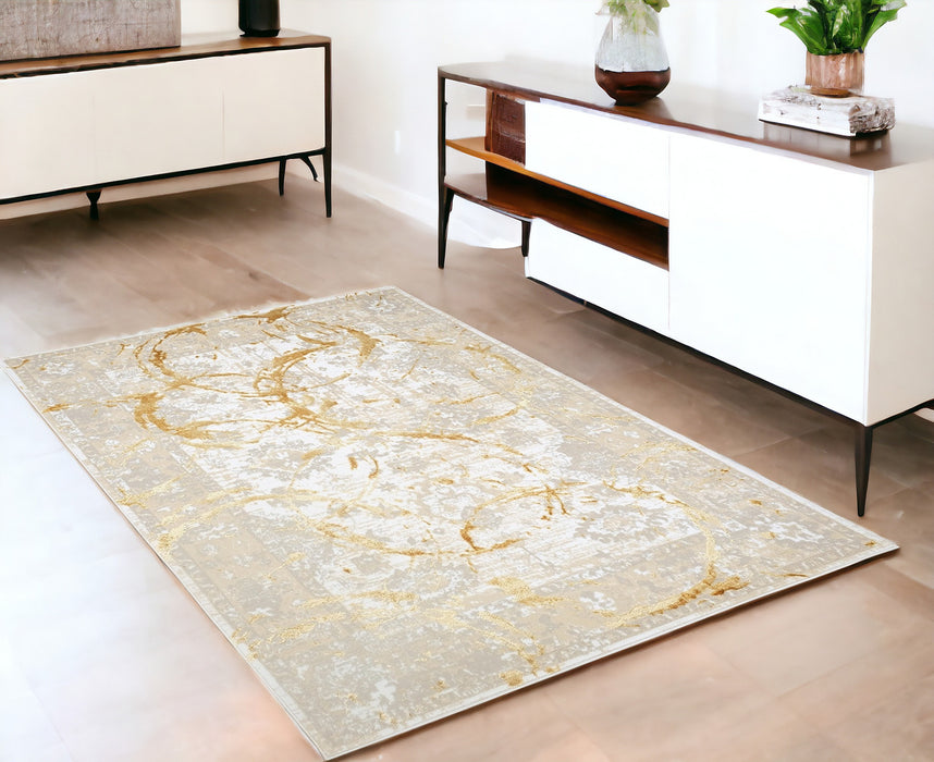 5' X 8' Beige and Gold Abstract Area Rug